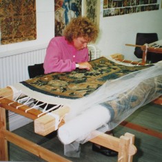 Annabel Wylie working on a carpet