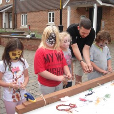 Teaching children medieval finger-braiding (also known as 'medieval friendship bracelets') at a West Kent Housing Family Fun Day in Seal
