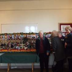 Some of the 55 volunteers seeing the finished tapestry for the first time after two years of individual and group work