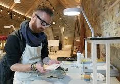 Jan Cutajar with a 17th century letter, in the Knole Conservation Studio