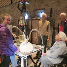 Kay Stratford and her sons with conservator Claudia Davies in the Knole Conservation Studio, 2017