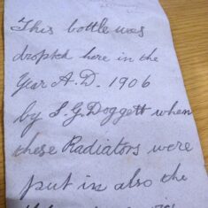 Handwritten  and left in a bottle by Sidney Doggett in 1906 while he was installing radiators in the Knole Attics