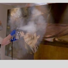 Sarah spray varnishing Reynolds painting in the Studio | NT Images