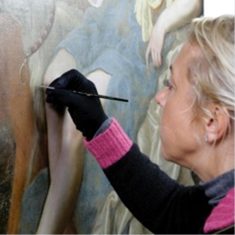 Sophie working with a sable brush on the Wootton painting